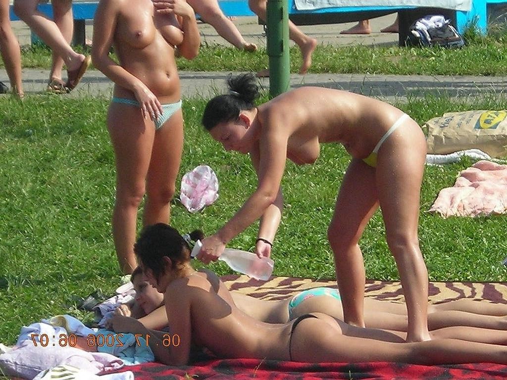Nude teenies have fun gathered at a public beach