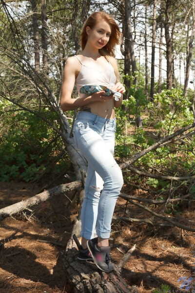Youthful pretty Dominica falls off faded jeans to show her smooth head love-cage in the woods