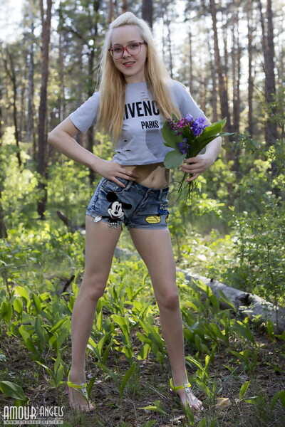 Nerdy fairy-haired Nika grasps a bunch of wildflowers during the time that getting nude atop a log