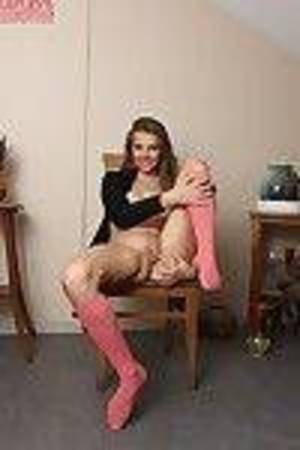 Amateur with diet shape Kira is sitting on the chair with amplify legs
