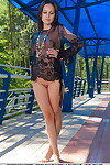 Erotic exemplar Bogdana B squats outside in sheer lace dominant swelling her legs