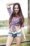 Slim youngster Li Moon sheds her country dear attire on bench in the woods
