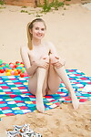 Model Nimfa sheds her short on the beach to show her mini marangos & cage of love