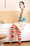 Infant solo gal removes striped OTK socks ahead of wanking in shower tub