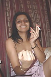 Indian dear caresses she\'s during her costume even as very a cigarette