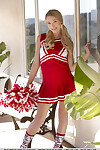 Fascinating youthful doll Riley Anne takes off her cheerleader outfit and cotton underwear