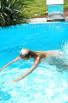 Young blonde Christen is swimming in the pool naked and masturbating