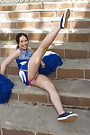 Sexy cheerleader spreading her legs and rubbing her slit outdoor