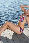 Infant white hotty with a attractive face takes off her bikini on lakeside dock