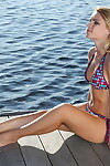Infant white hotty with a attractive face takes off her bikini on lakeside dock