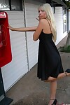 Golden-haired infant Jana Jordan flashes her underwear at a public phone