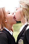 Amateur schoolgirls Cali Sparks and Kelly Greene tongue giving a kiss outdoors