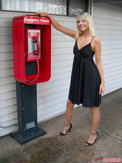 Golden-haired infant Jana Jordan flashes her underwear at a public phone