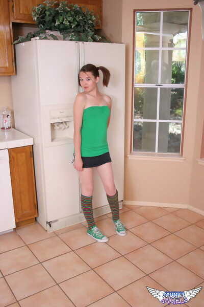 Pretty redhead Kir in pigtails & knee socks gets undressed down to string in the kitchen
