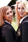 Young schoolgirls Cali Sparks and Kelly Greene tongue kissing outdoors