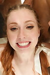 Redhead cheerleader takes cumshots on freckled face in an interracial group sex