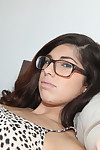 Hottie dark brown Ava Taylor is lying on the sofa and showing her cage of love