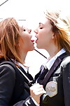 Amateur schoolgirls Cali Sparks and Kelly Greene tongue giving a kiss outdoors